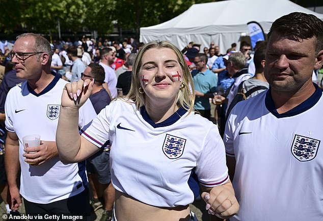 An England fan with face paint gets ready for the match this evening