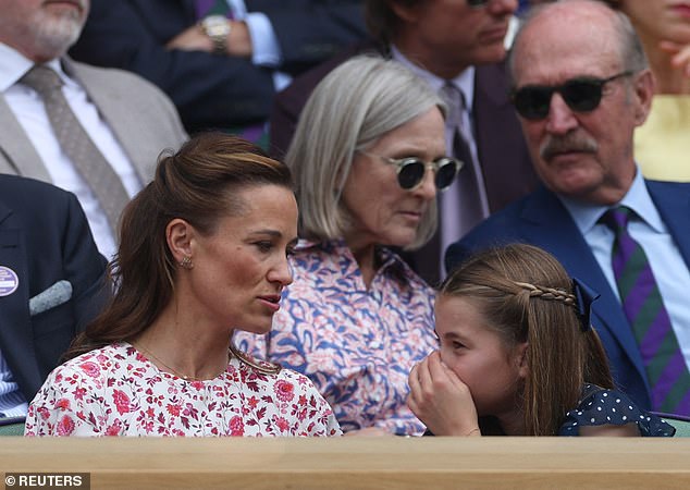 At one point in the match, Charlotte was pictured whispering gleefully to her auntie and covering her mouth with a hand