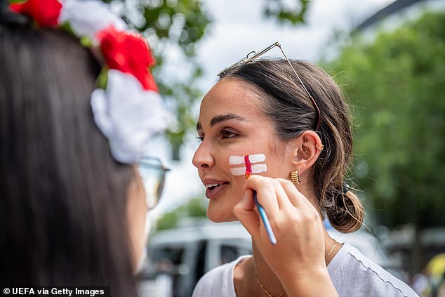 An England fan having her face painted ahead of the final tonight between England and Spain