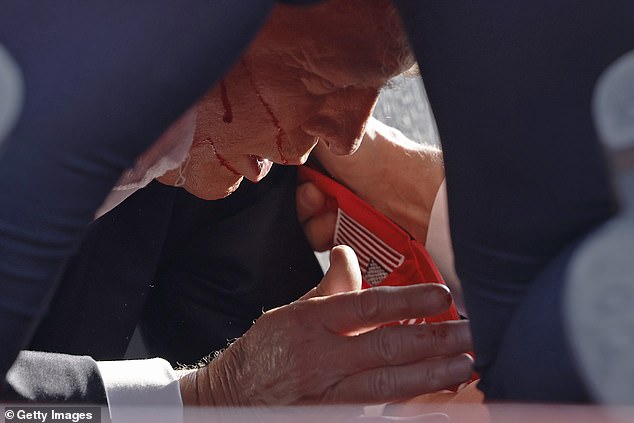 Trump had blood streaming down his cheeks as Secret Service agents put him to the floor