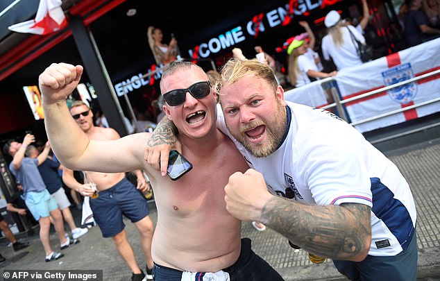 England fans stood outside a bar in Benidorm as they watch the match this evening