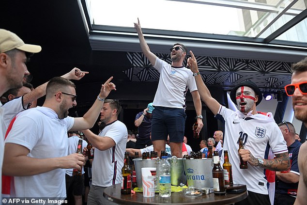 England fans in Benidorm cheer prior the UEFA Euro 2024 finale football match between Spain and England