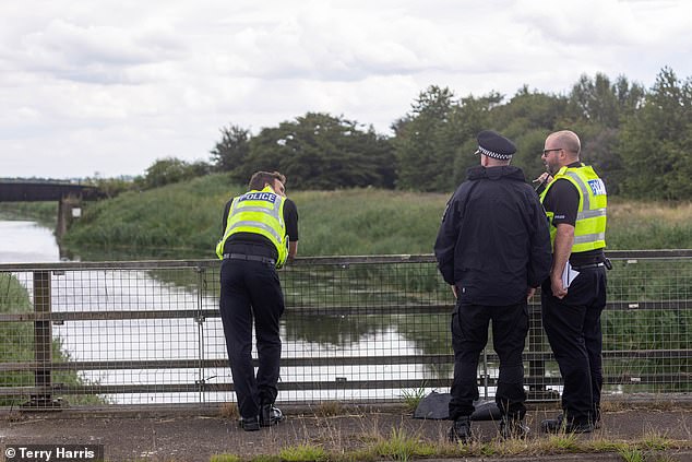 Police officers at the scene on Chain Bridge, March, in Cambridgeshire on Sunday