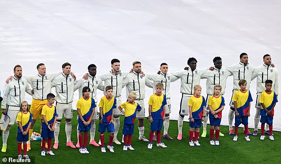 Soccer Football - Euro 2024 - Final - Spain v England - Berlin Olympiastadion, Berlin, Germany - July 14, 2024 England's players line up with young mascots during the national anthems before the match REUTERS/Angelika Warmuth