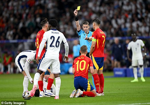 BERLIN, GERMANY - JULY 14: Referee Francois Letexier shows a yellow card to Dani Olmo of Spain after he fouls Declan Rice of England (obscured) during the UEFA EURO 2024 final match between Spain and England at Olympiastadion on July 14, 2024 in Berlin, Germany. (Photo by Stu Forster/Getty Images)