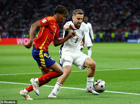 Soccer Football - Euro 2024 - Final - Spain v England - Berlin Olympiastadion, Berlin, Germany - July 14, 2024 Spain's Lamine Yamal in action with England's Luke Shaw REUTERS/Lisi Niesner