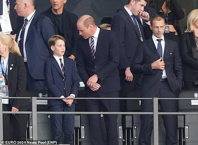 Prince William is seen chatting to his soon moments before kick-off, with the pair looking smart in navy blue suits and ties