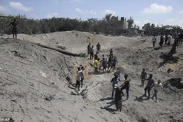 People search for bodies and survivors at the site of an Israeli strike in Gaza on July 13, 2024