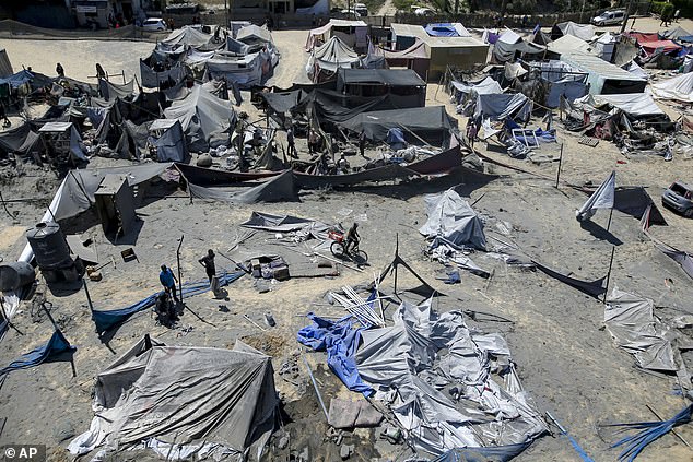 Palestinians inspect the damage at a site hit by an Israeli bombardment on Khan Younis, southern Gaza Strip, Saturday, July 13, 2024