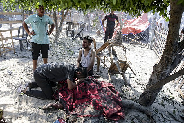 Palestinians mourn over the body of a relative killed in an Israeli bombardment on Khan Younis, southern Gaza Strip, Saturday, July 13, 2024