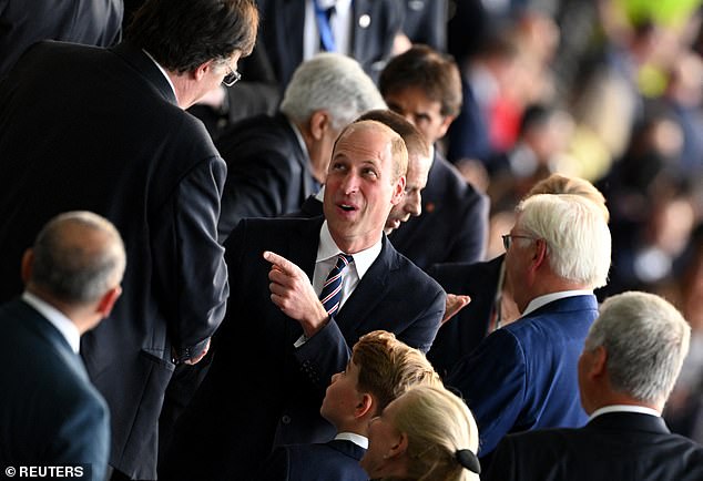 But his father William, 42, was more relaxed, smiling and joking with fellow guests at the game