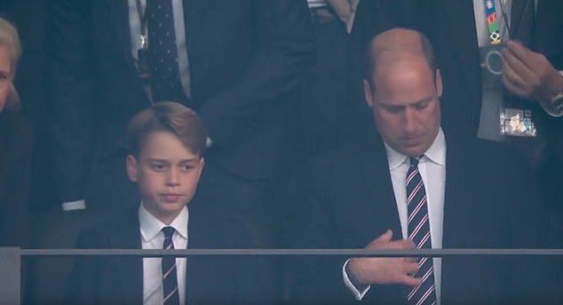 Just before the national anthem started playing, the royal father-and-son were also seen sitting in the stands - with Prince George straightening his tie moments before William did the same