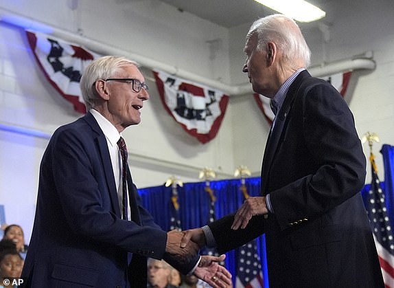 Wisconsin Gov. Tony Evers, left, greets President Joe Biden at a campaign rally at Sherman Middle School in Madison, Wis., Friday, July 5, 2024. (AP Photo/Manuel Balce Ceneta)