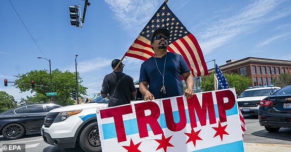 epa11478426 Supporters of former President Donald J. Trump participate in a small Trump Unity Rally in Chicago, Illinois, USA, 14 July 2024. Trump was injured by a bullet in an assassination attempt on 13 July during a campaign rally in Butler, Pennsylvania.  EPA/SHAWN THEW