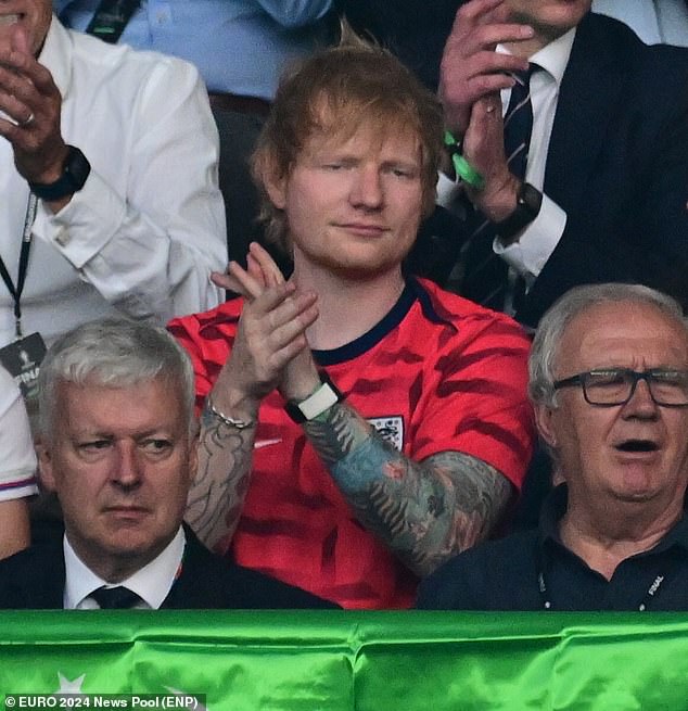 Ed sported a red England shirt as he sat beside Cherry, 32, who wore white kit and a cap as she shouted her support for the players