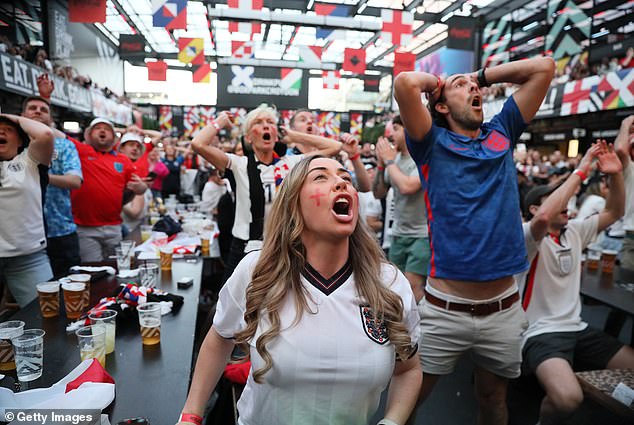 Fans are pictured at the Boxpark in Croydon as they watched the drama unfold last night