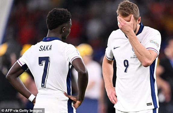 England's forward #09 Harry Kane and England's forward #07 Bukayo Saka react after the UEFA Euro 2024 final football match between Spain and England at the Olympiastadion in Berlin on July 14, 2024. (Photo by Kirill KUDRYAVTSEV / AFP) (Photo by KIRILL KUDRYAVTSEV/AFP via Getty Images)