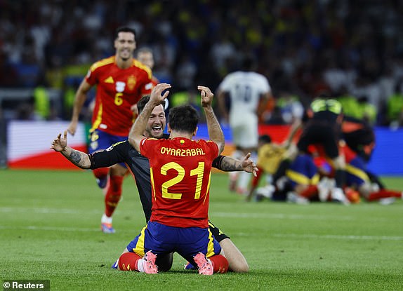 Soccer Football - Euro 2024 - Final - Spain v England - Berlin Olympiastadion, Berlin, Germany - July 14, 2024 Spain's Mikel Oyarzabal and Alex Remiro celebrate after winning the final REUTERS/Wolfgang Rattay