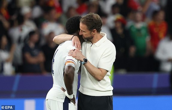 epa11478763 England head coach Gareth Southgate hugs Marc Guehi of England after losing the UEFA EURO 2024 final soccer match between Spain and England, in Berlin, Germany, 14 July 2024.  EPA/FRIEDEMANN VOGEL