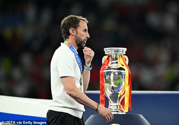 BERLIN, GERMANY - JULY 14: Gareth Southgate, Head Coach of England, walks past the UEFA Euro 2024 Henri Delaunay Trophy after the UEFA EURO 2024 final match between Spain and England at Olympiastadion on July 14, 2024 in Berlin, Germany. (Photo by Michael Regan - UEFA/UEFA via Getty Images)