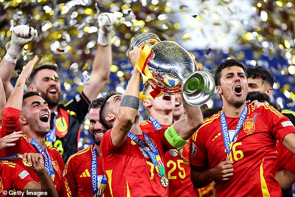 BERLIN, GERMANY - JULY 14: Alvaro Morata of Spain lifts the trophy with team mates during the UEFA EURO 2024 final match between Spain and England at Olympiastadion on July 14, 2024 in Berlin, Germany. (Photo by Robbie Jay Barratt - AMA/Getty Images)