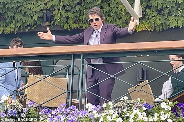 The 62-year-old Mission: Impossible producer-star - rocking his signature shades - looked dapper wearing an eggplant-colored suit with a white button-up and lavender necktie