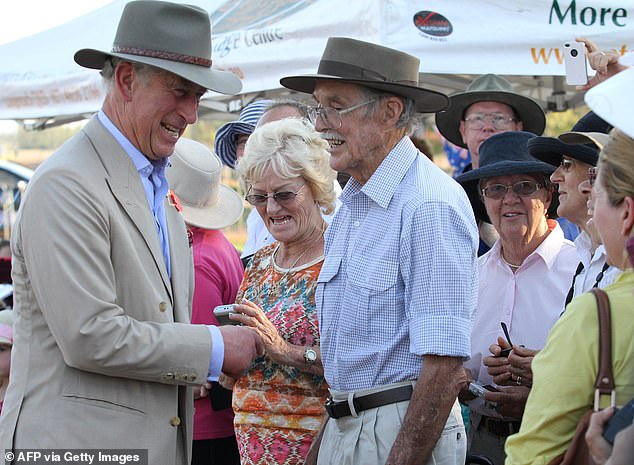 Charles meets locals after he and his wife Camilla (not pictured) arrived at Longreach in outback Queensland on November 5, 2012