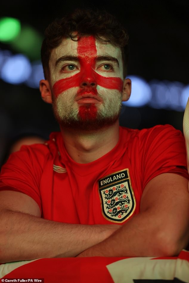 Arms folded, this England fan in Berlin shows his anguish at England's loss