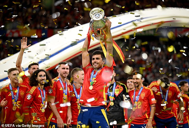 Jubilant Alvaro Morata of Spain lifts the UEFA Euro 2024 cup after his team clinched victory