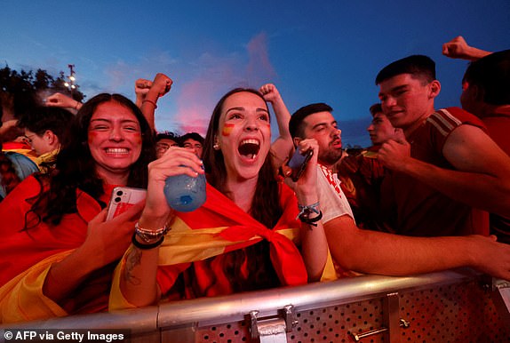 Spain fans react as they watch on a giant screen the UEFA Euro 2024 final football match between Spain and England, in Madrid, on July 14, 2024. (Photo by OSCAR DEL POZO / AFP) (Photo by OSCAR DEL POZO/AFP via Getty Images)