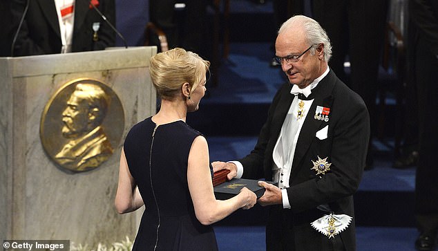 Alice Munro, laureate of the Nobel Prize in Literature, represented by her daughter Jenny Munro (L) receives her Nobel Prize from King Carl XVI Gustaf of Sweden in 2013