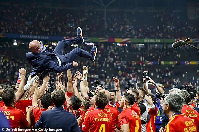 While head coach Luis de la Fuente of Spain is thrown into the air by the players as celebrations went into overdrive on the pitch