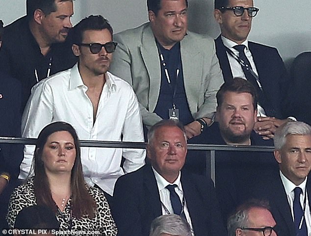 The singer, cut a dapper figure in a white shirt and sunglasses as he attended the highly-anticipated match with close pal James Corden