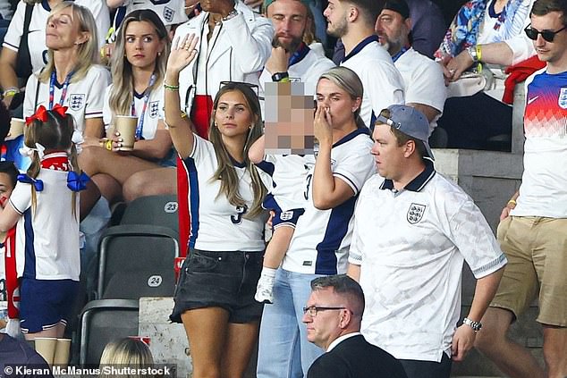 Pictured: Harry Kane's wife seen holding one of their children during the Euro 2024 final in Berlin