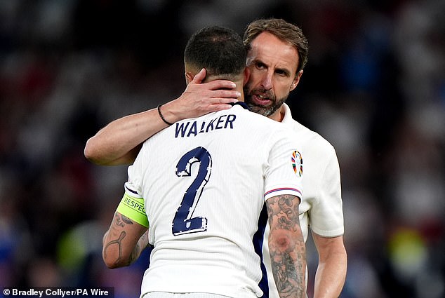 England defender Kyle Walker is consoled by Gareth Southgate following defeat to Spain