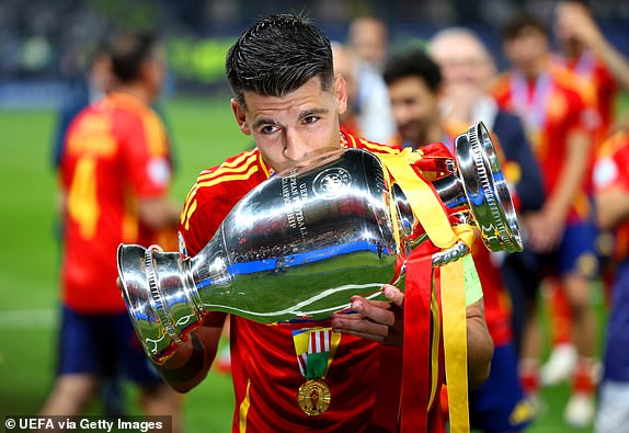 BERLIN, GERMANY - JULY 14: Alvaro Morata of Spain kisses the UEFA Euro 2024 Henri Delaunay Trophy after his team's victory during the UEFA EURO 2024 final match between Spain and England at Olympiastadion on July 14, 2024 in Berlin, Germany. (Photo by Joosep Martinson - UEFA/UEFA via Getty Images)