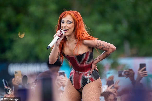 Doja displayed her tattooed arms in the corset and added a silver cross belly chain