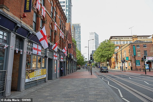 BIRMINGHAM -- England flags droop and flutter in the wind along a quiet Broad Street on Monday