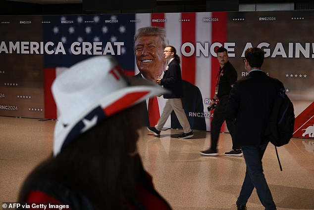 An attendee at the Trump convention walks through the lobby of the Fiserv Forum