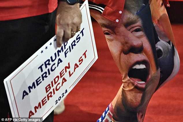 An attendee wears pants featuring the face of former US President and 2024 Republican presidential candidate Donald Trump during the second day of the 2024 Republican National Convention at the Fiserv Forum in Milwaukee, Wisconsin