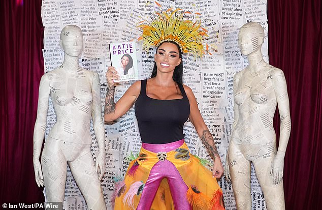 Katie Price wowed in a busty look as she posed during a photo call for her new memoir This Is Me at the Royal Vauxhall Tavern in London on Wednesday