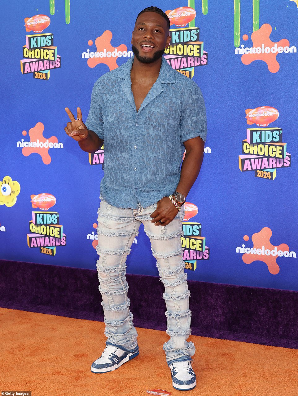 Good Burger star, Kel Mitchell, flashed a cheerful smile and a peace sign upon arriving to the venue