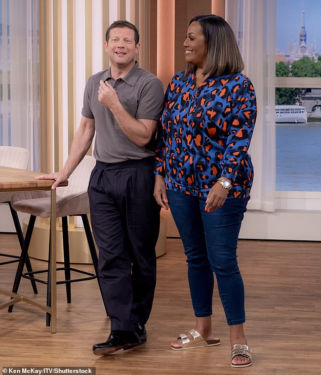 The ITV presenter, 49, looked incredible in a pair of blue denim skinny jeans for the second time this week which she teamed with a colourful leopard print blouse (pictured with Dermot O'Leary)