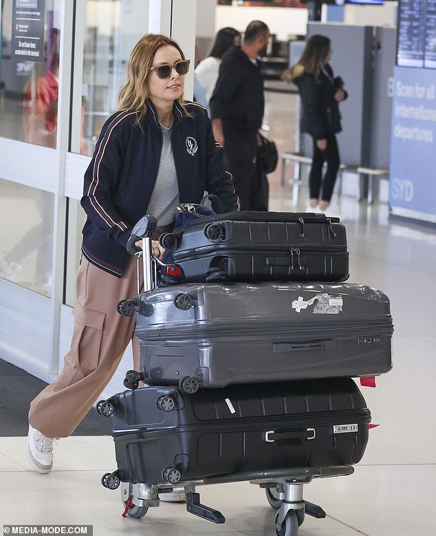 She completed her look with brown pants and white sneakers, accessorised with stylish sunglasses, and looked focused as she wheeled her luggage through the bustling terminal