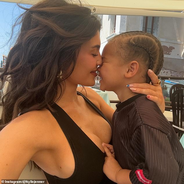 The 26-year-old makeup mogul posted photos cuddling up to her little boy, who she shares with ex-boyfriend Travis Scott, 33