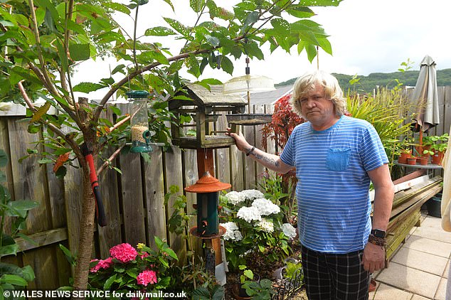 Bird lover Simon Mayne's (pictured) efforts soon saw his garden visited by an array of new avian visitors including woodpeckers, warblers and goldfinches