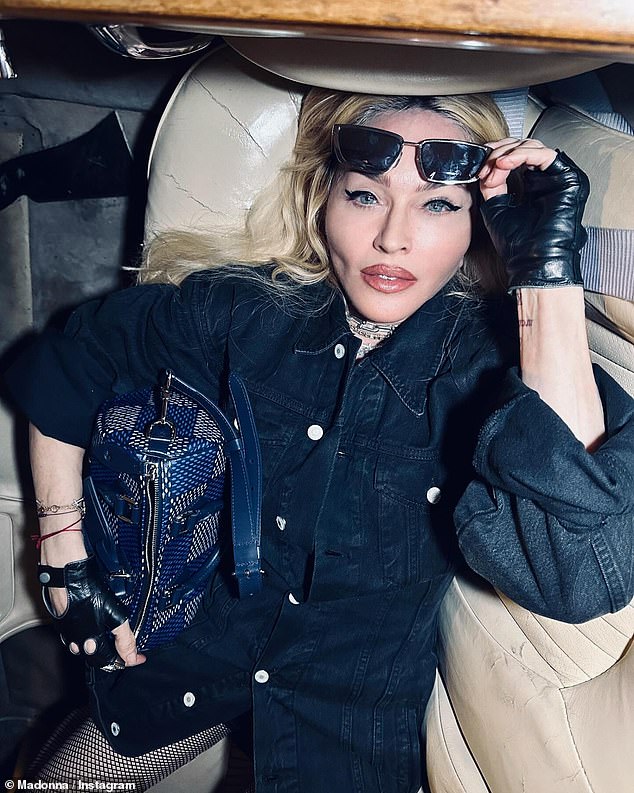 Madonna, 65, posed up a storm for a racy photoshoot in a vintage Jaguar on Sunday after arriving in London