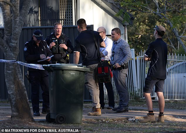 Officers and detectives are seen talking to the plumbers after the repair works were carried out