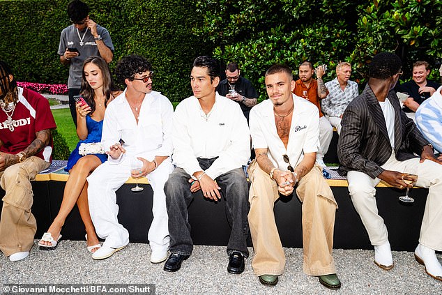 Romeo opted for a white loose-fitting viscose shirt from the brand (pictured with L-R Meg Donnelly, Gavin Leatherwood and Evan Mock)