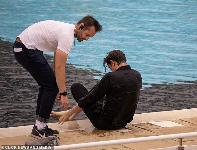 The Doctor Who star sat by the edge as he was given further notes and direction, before a crew member handed him a towel